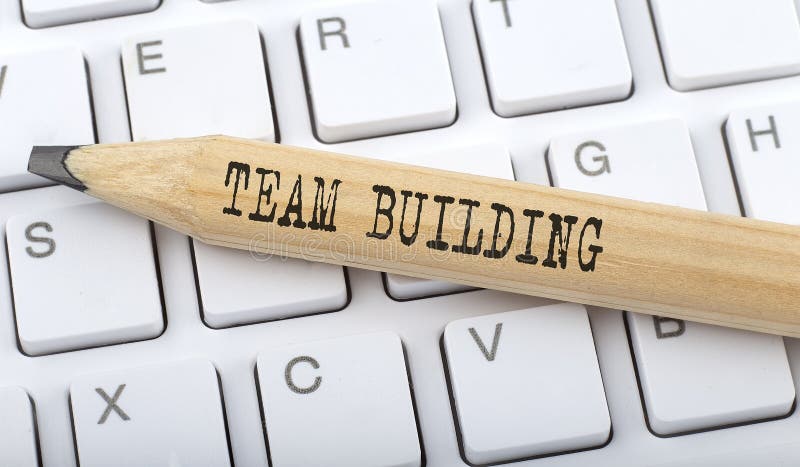 TEAM BUILDING text on pencil on the keyboard on background stock images