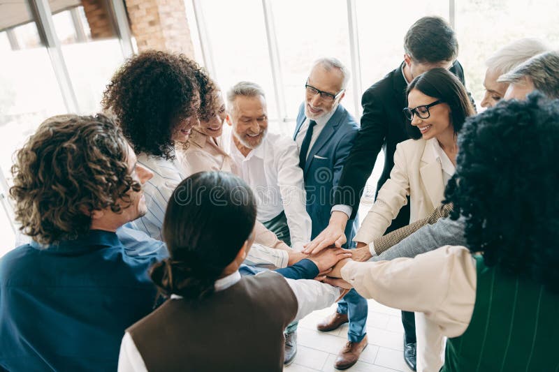 Team of business professionals collaborating and supporting each other in a corporate office environment, emphasizing stock photo