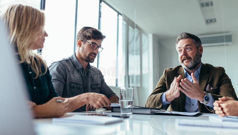 Team of business professionals having a meeting stock photos Team of business professionals having a meeting stock photos