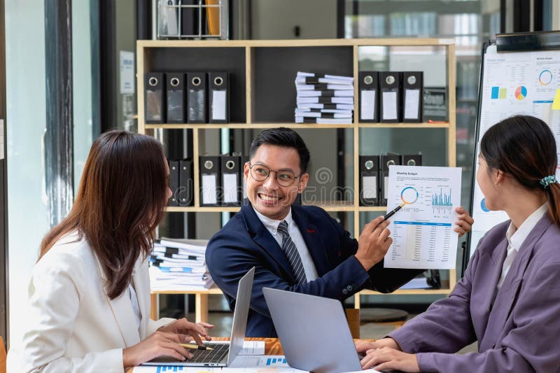 A Team of Businessmen Plan with Their Laptops and Graph Charts for ...