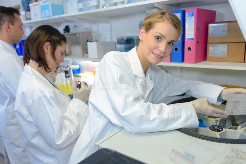 Team chemists working with devices in laboratory royalty free stock image