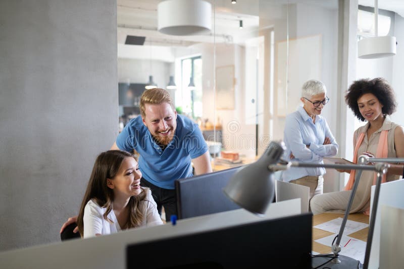 Team of colleagues brainstorming together while working in modern office stock image Team of colleagues brainstorming together while working in modern office stock image