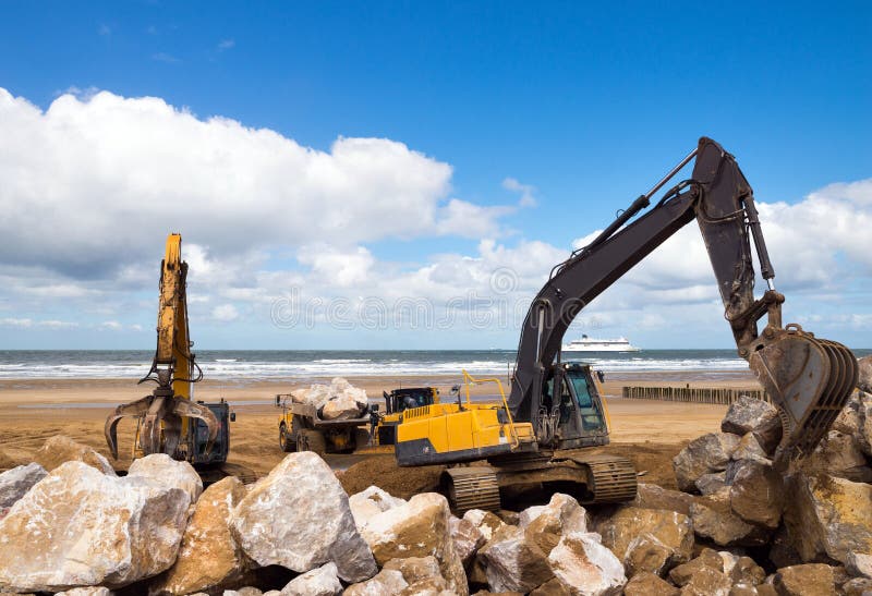 Crane or Excavator Equipped with a Grapple Handling Large Rocks Stock