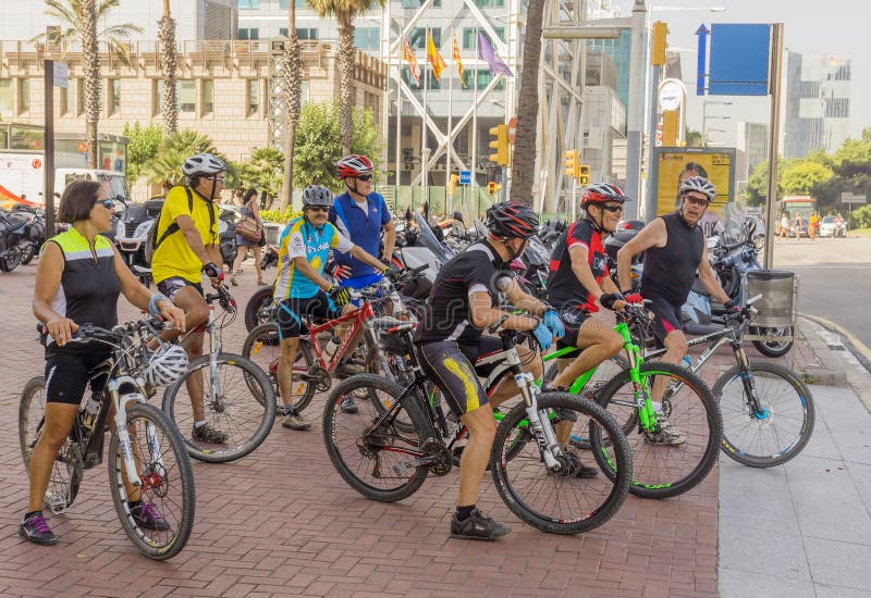 BARCELONA, SPAIN - JULY 6, 2015: Team cycling enthusiasts on the streets of Barcelona. Barcelona, Spain - July 6, 2015: Team cycling enthusiasts on the streets of Barcelona. People cycling on the street.