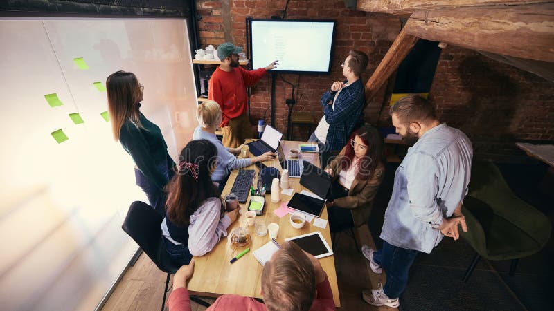 Team discussion around table in modern open office royalty free stock images
