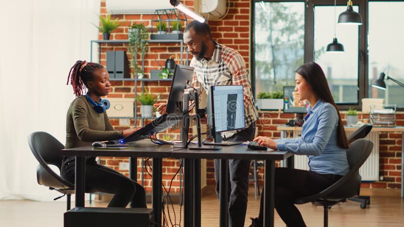 Team of diverse colleagues developing digital software in production studio stock photo