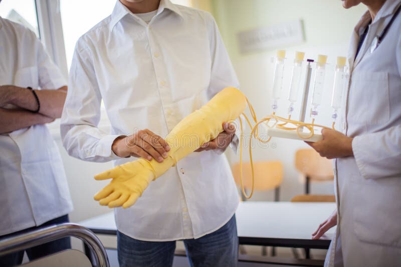 Team of Doctors Studies the Artificial Arm Stock Photo Image of care, cure 215647570