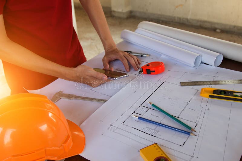 Engineer Man and Architect Drawings Blueprint at Construction Site.Home