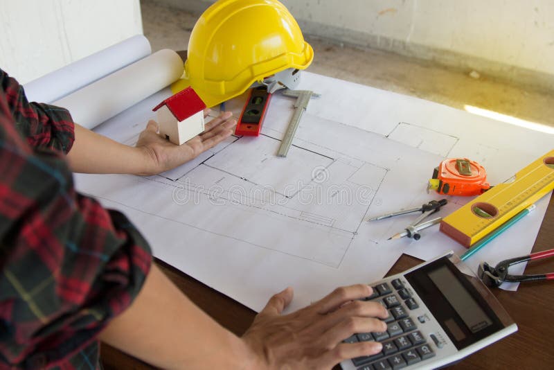Engineer Man and Architect Drawings Blueprint at Construction Site.Home