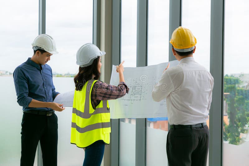 Team of Engineers Architects Working and Standing Around Table Working