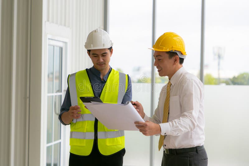 Team of Engineers Architects Working and Standing Around Table Working