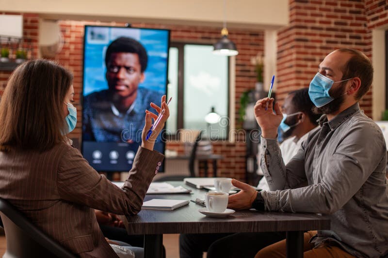 Team listens to client on video call stock photography