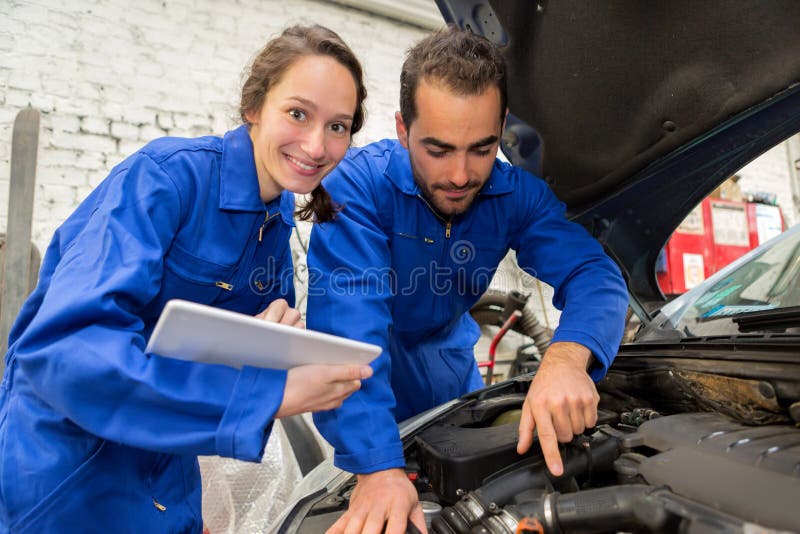 Team of mechanics working at the garage