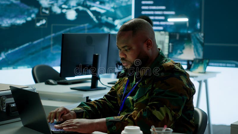 Team of military professionals in control center monitors satellite intelligence stock images