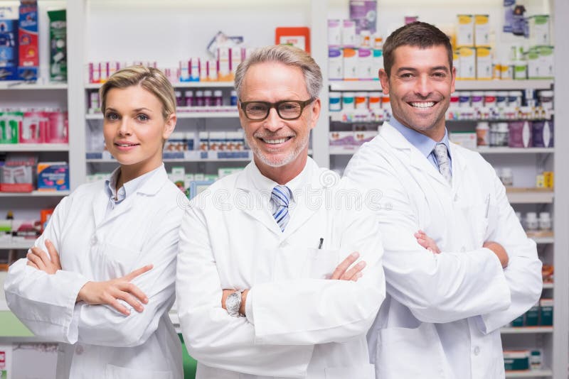 Team of pharmacists smiling at camera