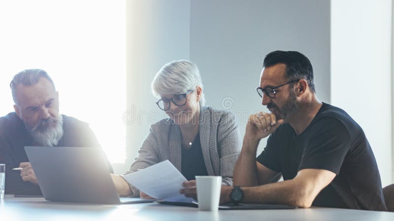 Team of professionals discussing new project stock photos Team of professionals discussing new project stock photos