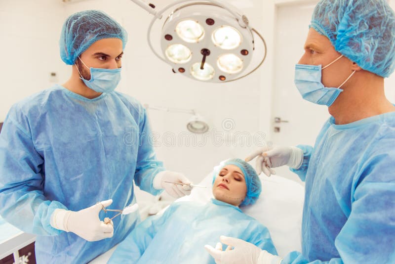 Team surgeons at work stock photo. Image of expression 69372426