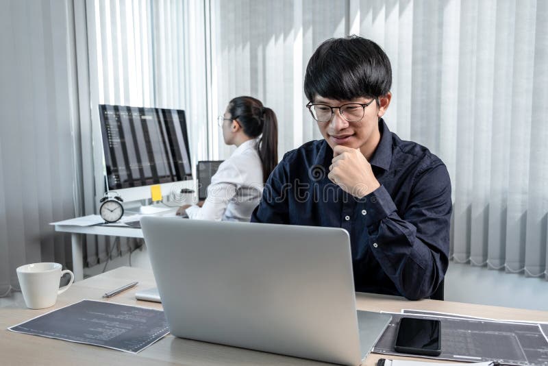 Team of two professional programmers working on website projects in software development on the desktop computer and making coding royalty free stock images