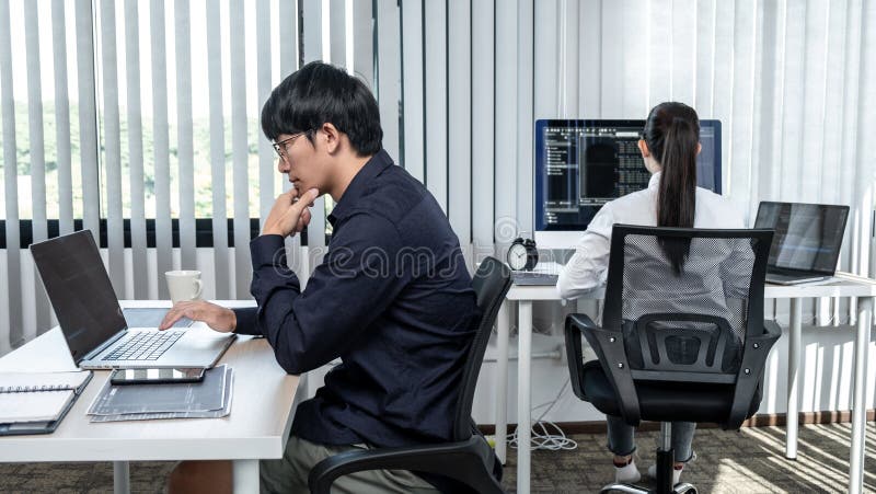 Team of two professional programmers working on website projects in software development and making coding and typing data code stock photo