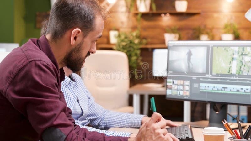 Team of video editors analyzing film montage after editing visual effects royalty free stock photos