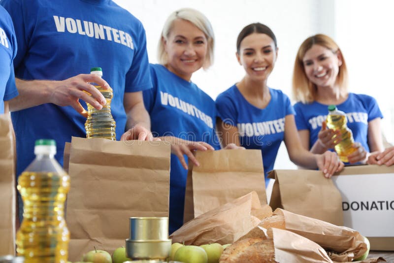 Team Of Volunteers Collecting Food Donations At Table Stock Image