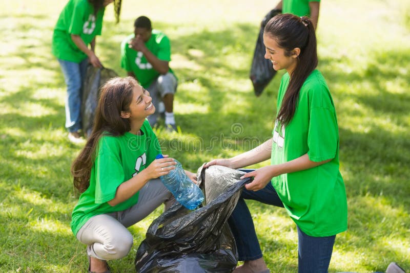 Team of young volunteers picking up litter in the park. Team of young volunteers picking up litter in the park