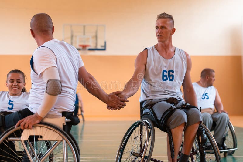 A Team of War Veterans in Wheelchairs Playing Basketball, Celebrating