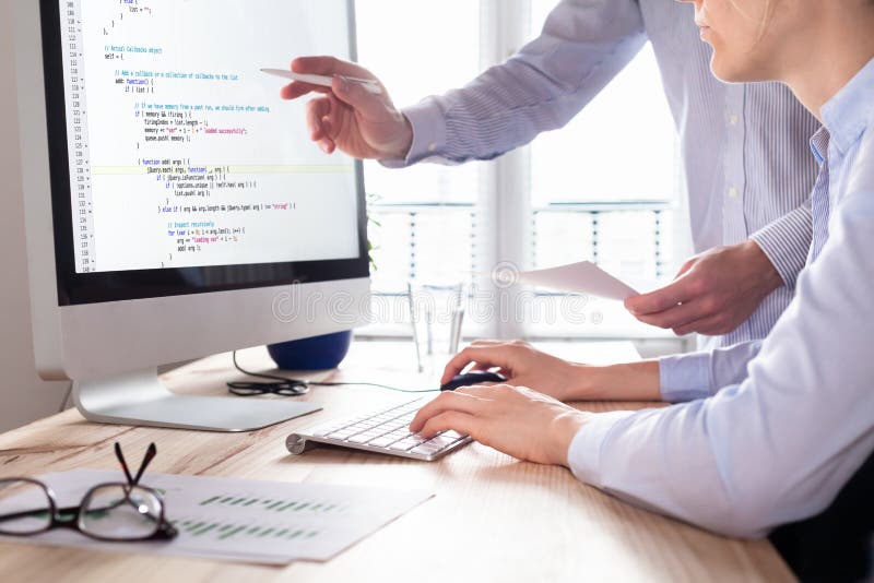 Team of web app developers coding website source code, debugging stock photo