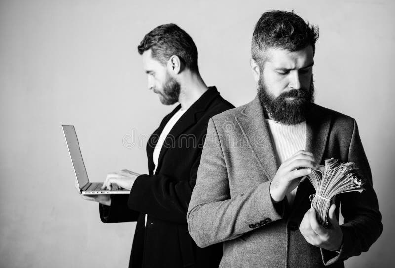 Team of web developer with laptop and sales manager with cash money. Developing applications. Digital technology. IT royalty free stock photos