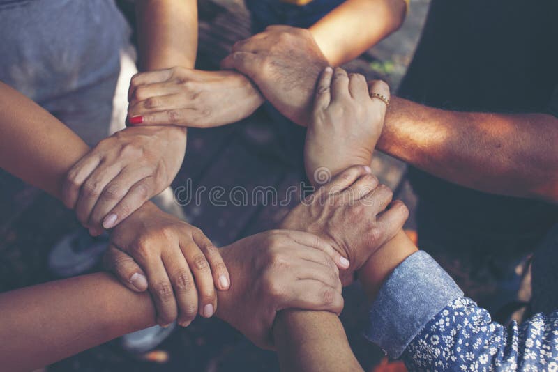 Team Work Concept : Group of Diverse Hands Together Cross Processing of young people in the nature royalty free stock photography