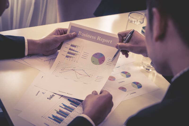 Team working together analyzing business data on the table royalty free stock image Team working together analyzing business data on the table royalty free stock image