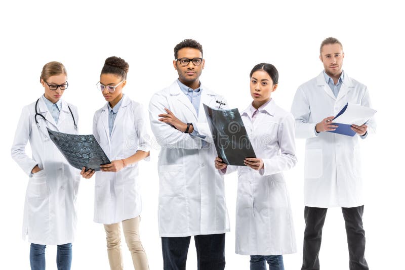 Team of Young Professional Doctors in White Coats Standing Together
