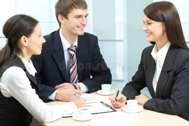 Business-team of three smiling people discussing new working ideas. Business-team of three smiling people discussing new working ideas