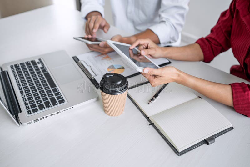 Teamwork of business casual colleagues, consultation new strategy plan business and market growth on financial document graph royalty free stock image Teamwork of business casual colleagues, consultation new strategy plan business and market growth on financial document graph royalty free stock image