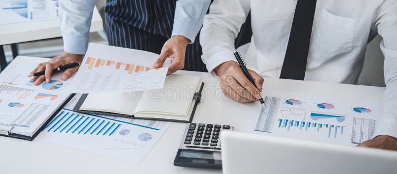 Teamwork of business team consulting market growth on financial document graph report statistics, professional presentation stock photography