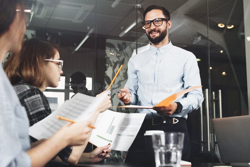Teamwork meeting and brainstorming. Coworking people working together in loft space royalty free stock image Teamwork meeting and brainstorming. Coworking people working together in loft space royalty free stock image