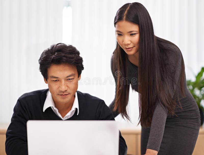 Teamwork, mentor and help with laptop in office or businessman learning from support of woman. Feedback, advice and royalty free stock photography