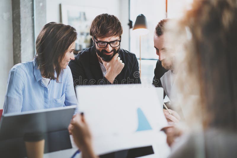 Teamwork process at modern office.Young coworkers team discussing new startup project at meeting room.Blurred background. stock photo Teamwork process at modern office.Young coworkers team discussing new startup project at meeting room.Blurred background. stock photo