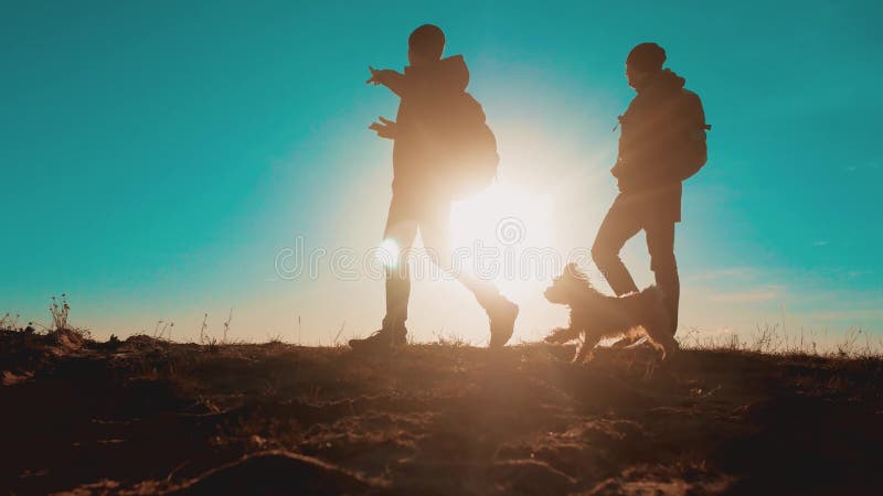 teamwork zwei Touristenwanderermänner mit Rucksäcken bei Sonnenuntergang gehen, Reise zu wandern Wanderer wagen und der Hund gehe