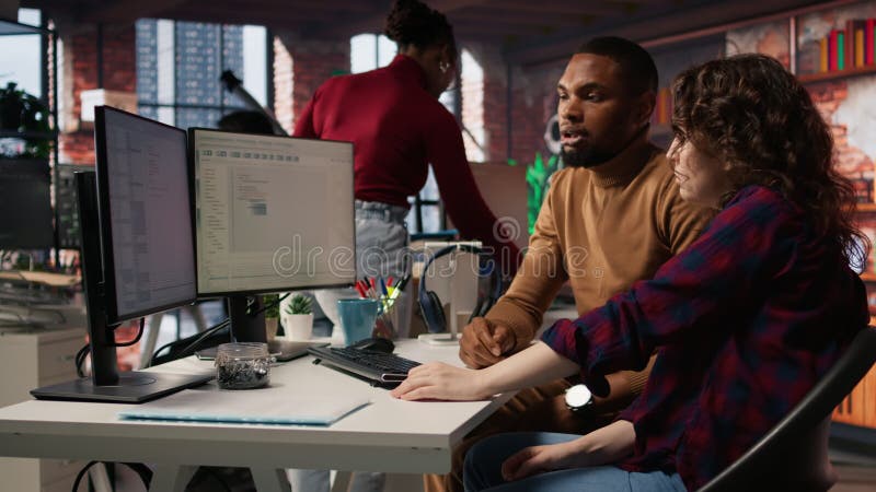 Teamworking colleagues using computer in software development agency stock video