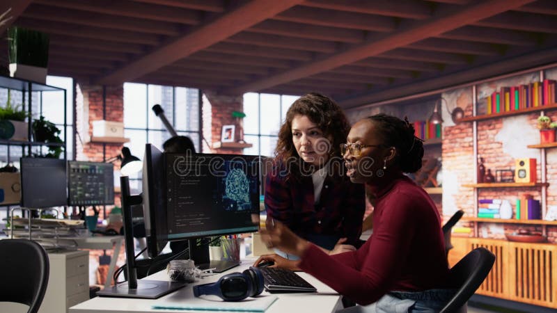 Teamworking engineers coding advanced AI algorithm in startup stock footage