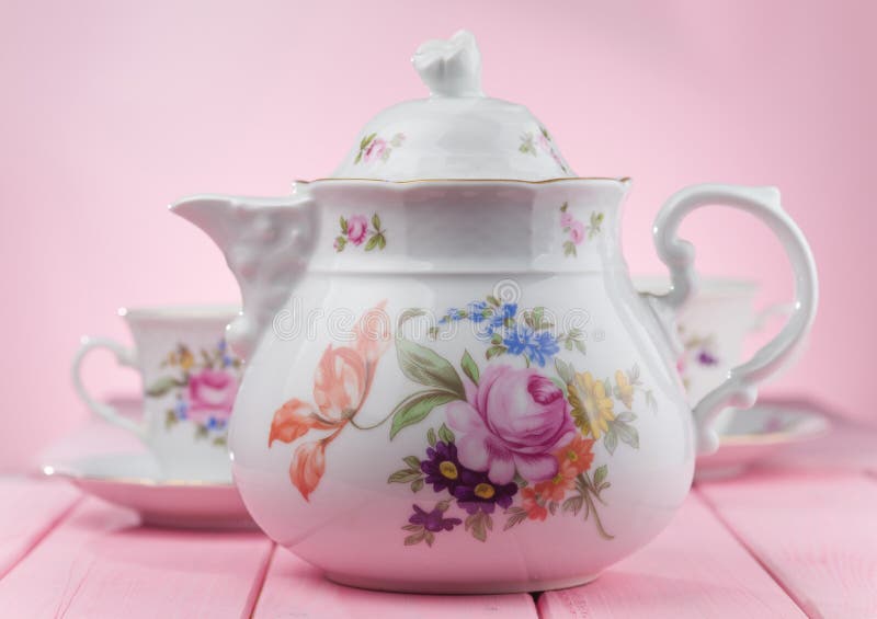 Teapot with Cups on a Pink Background. Stock Photo Image of