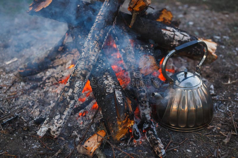A teapot with tea stands by the fire. Evening photography royalty free stock photography A teapot with tea stands by the fire. Evening photography royalty free stock photography