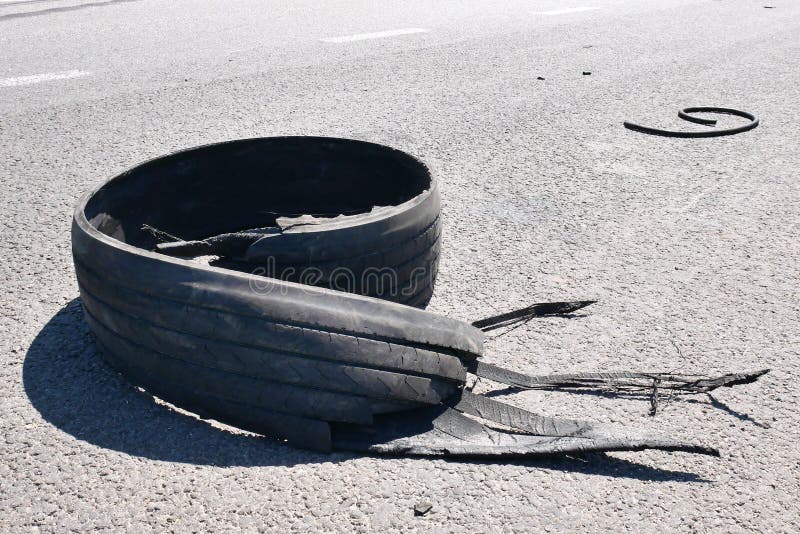 Tear rubber truck tire on asphalt road highway