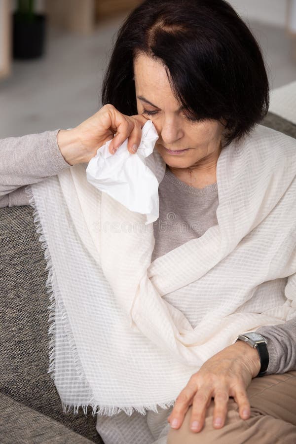 Tearful mature woman at home royalty free stock photo