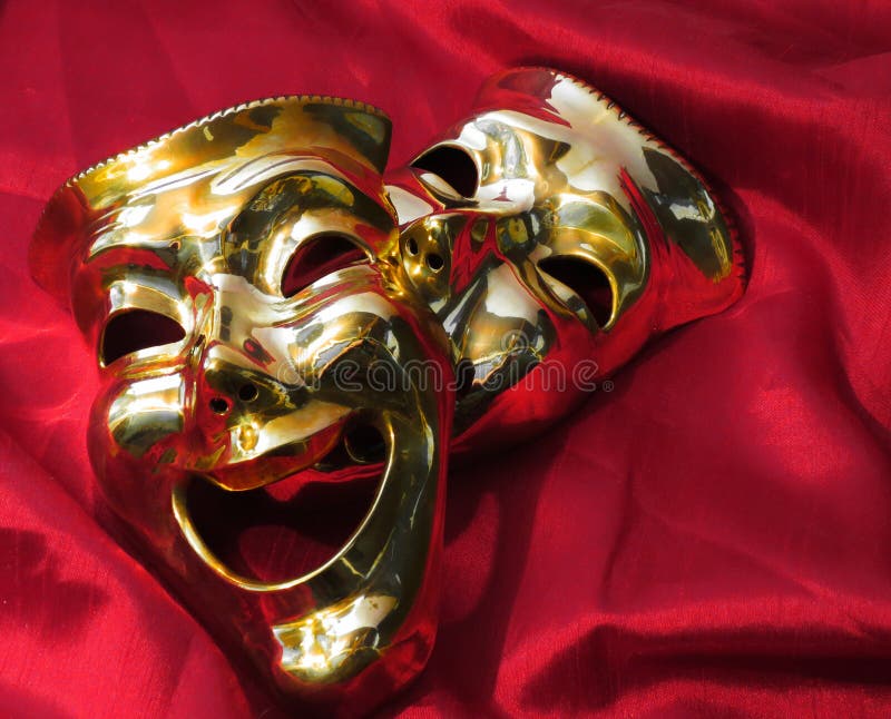 Brass theater masks on a red velvet backround. Brass theater masks on a red velvet backround