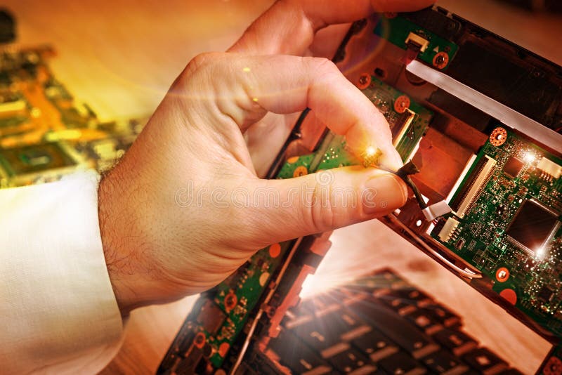 Tech fixes laptop motherboard in service center