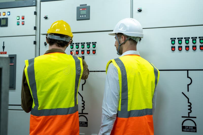 Technical Worker with Engineer Working and Checking in Control Room
