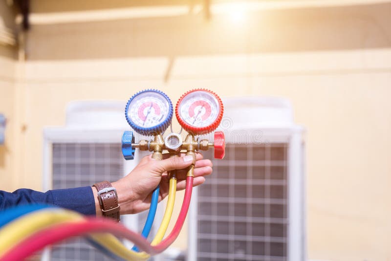 Technician Vacuum Pump Evacuates and Checking New Air Conditioner