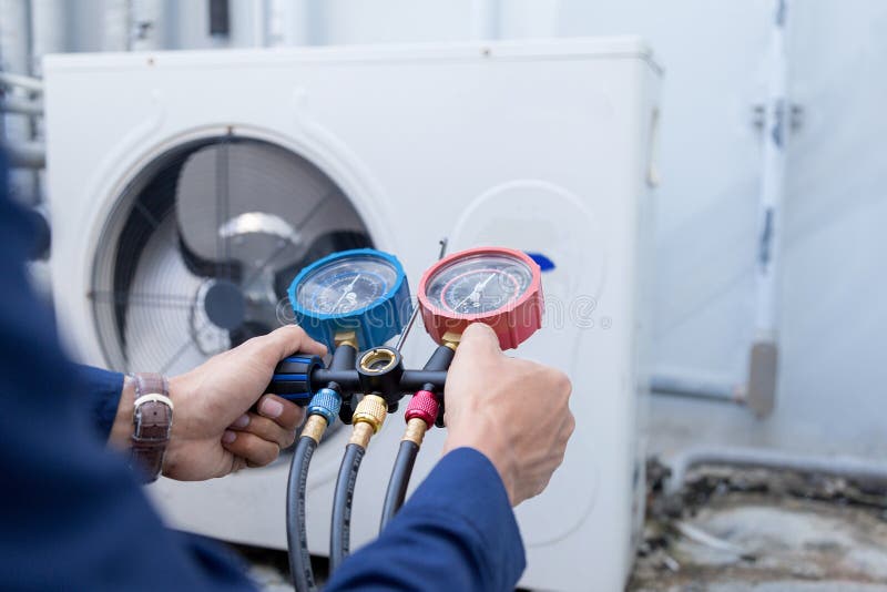 Technician is Checking Air Conditioner ,measuring Equipment for Filling